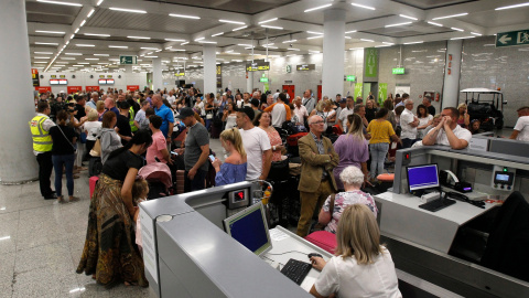 Varios turistas hacen cola frente a los mostradores de la compañía Thomas Cook en el aeropuerto de Palma de Mallorca (Baleares).  Isaac Buj - Europa Press