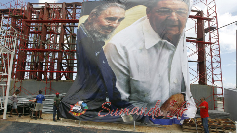 Varios obreros despliegan en La Habana una imagen gigante del presidente cubano Raúl Castro, junto a su hermano y líder de la revolución cubana Fidel Castro, con motivo de su 90 cumpleaños. EFE/Ernesto Mastrascusa