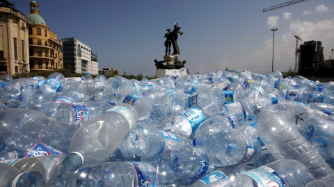 Reúnen botellas de agua para ser recicladas cerca de una estatua en la Plaza de los Mártires en Beirut, Líbano 25 de agosto de 2015. REUTERS / Jamal Saidi