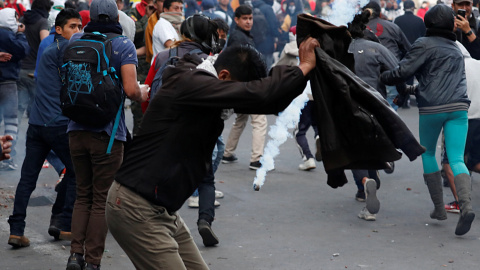 Los manifestantes corren y se cubren durante una protesta. REUTERS / Carlos Garcia Rawlins