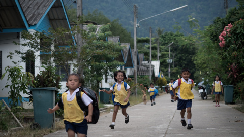 Un grupo de niños corre a la escuela en un nuevo municipio en el distrito de Khura Buri construido después del tsunami de Tailandia en 2004. NICOLAS ASFOURI (AFP)