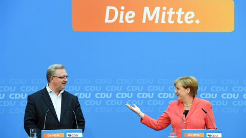 La canciller alemana, Angela Merkel y el candidato del CDU para las regionales de Berlín, Frank Henkel, en rueda de prensa tras la reunión de la ejecutiva de la Unión Cristianodemócrata (CDU), que sufrió una gran caída en las elecciones del