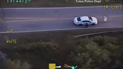 Imagen del video de la Policía de Tlsa (Oklahoma) en la que se ve a  Terence Crutcher de rodillas con las manos en alto, apuntado por varios agentes después de tener una avería en la carretera. REUTERS