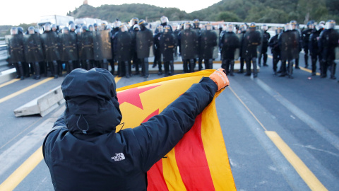 12.11.2019 / Un hombre frente a policías franceses en la autopista AP-7 en el lado francés de la frontera franco-española. REUTERS / Rafael Marchante