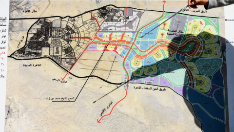 Un hombre usa un puntero para explicar el mapa de la nueva capital egipcia. - MOHAMED EL-SHAHED / AFP