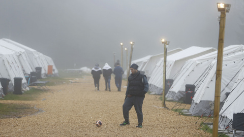 Un refugiado juega al fútbol para combatir las bajas temperaturas en el refugio temporal de Schwarzenborn (Alemania). REUTERS/Kai Pfaffenbach