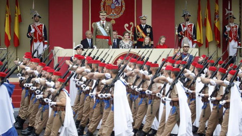 Los Reyes junto a sus hijas la Princesa de Asturias y la infanta Sofía, observan el paso de los Regulares de Ceuta, durante el desfile militar que han presidido dentro del acto central del Día de la Fiesta Nacional en el que se rinde homena