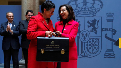 La nueva ministra de Asuntos Exteriores, Arancha González Laya (i), recibe su cartera de manos de la ministra de Defensa, Margarita Robles, durante la toma de posesión de su cargo este lunes 13 de enero de 2020 en la sede del Ministerio en 