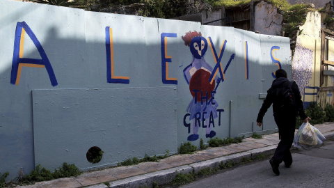 Un hombre pasa cerca de un muro pintado con un grafiti en el que se lee: "Alexis el Magnífico", en referencia al primer ministro griego, Alexis Tsipras, y sus negociaciones con el Eurogrupo. EFE