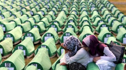 Dos mujeres se lamentan junto a los féretros en Srebrenica./ EFE