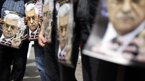 Varios palestinos portan carteles del presidente palestino, Mahmud Abás, en una manifestación en Ramala en marzo de 2014. - AFP