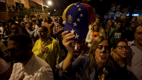 Un grupo de personas celebra la victoria obtenida por la coalición opositora Mesa de Unidad Democrática (MUD)  este lunes en Caracas./ EFE