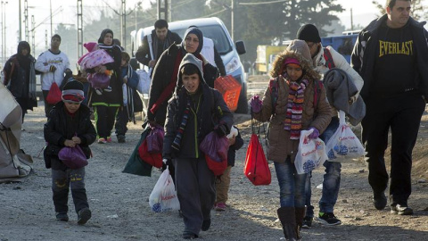 Un grupo de refugiados se dirige a cruzar la frontera entre Grecia y Macedonia. EFE