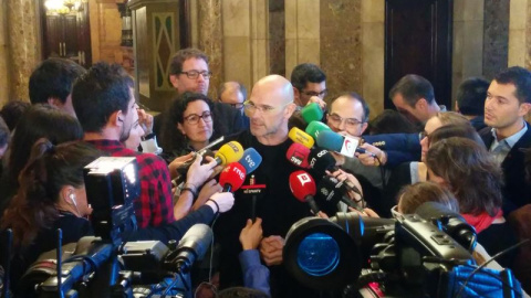 El cabeza de lista de Junts pel Sí (JxSí), Raül Romeva, rodeado de periodistas en los pasillos del Parlament. E.P.