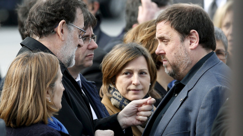 El presidente del Gobierno en funciones, Mariano Rajoy, conversa con el vicepresident y conseller de Finanzas, Oriol Junqueras, en presencia de president de la Generalitat, Carles Puigdemont, tras el acto de recuerdo de las víctimas del acc