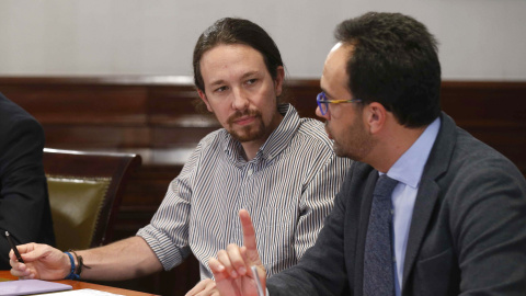 El líder de Podemos, Pablo Iglesias (i), y el portavoz socialista Antonio Hernando (d), durante la reunión que PSOE, Podemos y Ciudadanos mantienen hoy en el Congreso de los Diputados para explorar la posibilidad de negociar un acuerdo de g