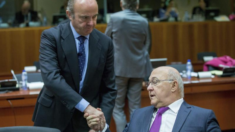 El ministro español de Economía, Luis de Guindos (i), saluda al ministro francés de Finanzas, Michel Sapin, a su llegada a la reunión de ministros de Economía y Finanzas de la Unión Europea, el Ecofin, en Bruselas (Bélgica) hoy, 6 de diciem