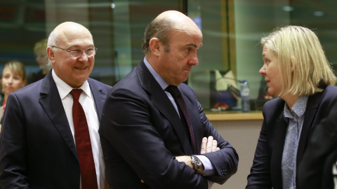 El ministro de Economía, Luis de Guindos, conversa con la ministra sueca de Finanzas, Magdalena Andersson, junto al ministro galo de Finanzas, Michel Sapin, antes del comienzo de la reunión del Ecofin, en Bruselas. EFE/Olivier Hoslet