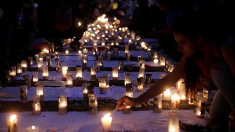 Candles are lit during a protest to demand justice for the victims of a fire at the Virgen de Asuncion children's shelter, in front of the National Palace in Guatemala City, Guatemala, March 11, 2017. REUTERS/Saul Martinez