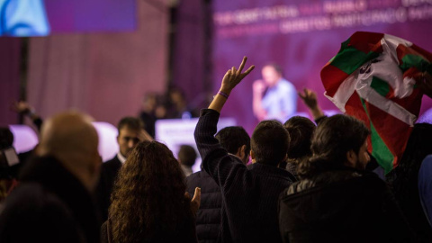 Un asistente a la Asamblea de Podemos hace el signo de la victoria, característico de los Errejonistas. | JAIRO VARGAS