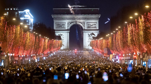 Personas celebran el año nuevo en los Campos Elíseos de París, Francia, el 1 de enero de 2022.