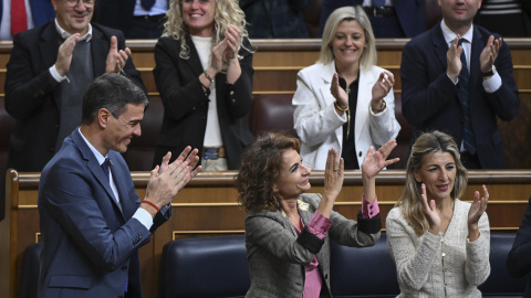 De izda a dcha; El presidente del Gobierno, Pedro Sánchez, y las vicepresidentas María Jesús Montero y Yolanda Díaz, aplauden durante el pleno celebrado este jueves en el Congreso de Los Diputados