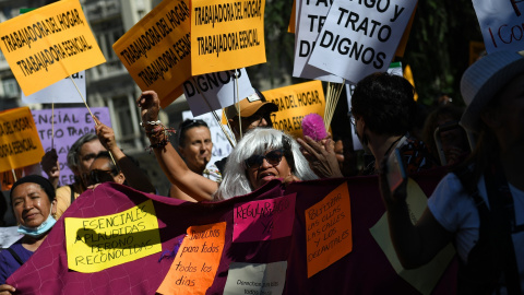 Varias empleadas domésticas durante una concentración de la Asamblea Feminista para celebrar la aprobación del convenio que vela por los derechos de los empleados domésticos, en la Plaza de las Cortes frente al Congreso de los Diputados