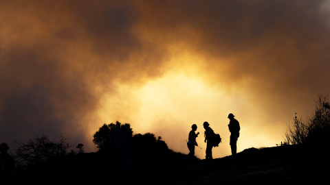 Tres bomberos bregan contra el fuego en California el pasado 11 de enero.