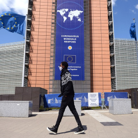 Un hombre con mascarilla pasa por delante de la sede de la Comisión Europea, en Bruselas. REUTERS/Johanna Geron