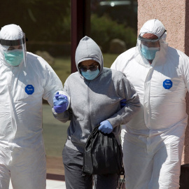 Personal sanitario traslada desde el Centro de Acogida, Emergencia y Derivación de Cruz Roja de Málaga a una de las personas afectadas por la covid-19 al hospital Clínico malagueño. EFE/Daniel Pérez