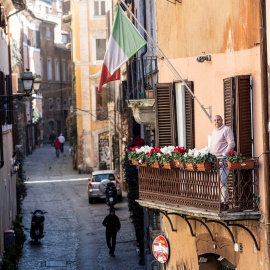 A man looking out onto the balcony of his house in the Trastevere district deserted due to the coronavirus outbreak in Rome, Italy 16 March 2020. Italy is under lockdown in an attempt to prevent the spread of the pandemic Coronavirus. Several European cou