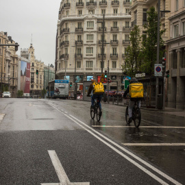 tRABAJADORES DE gLOVO cruza la Gran Vía de Madrid durante el estado de alarma decretado por el coronovirus, el 31 de marzo de 2020.-JAIRO VARGAS