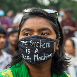 Una estudiante con una mascarilla que dice "El sistema es una máquina violadora" participa en una protesta contra la violación y las agresiones sexuales en Dhaka, Bangladesh. /EFE