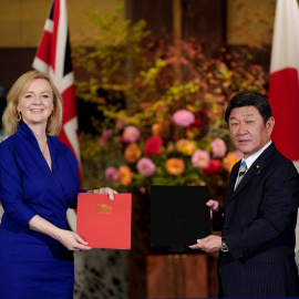 La Secretaria de Estado de Comercio Internacional británica Elizabeth Truss (d) y el Ministro de Relaciones Exteriores japonés Toshimitsu Motegi (i) intercambian documentos de acuerdo para la asociación económica entre sus países. EFE/KIMIMASA MAYAMA