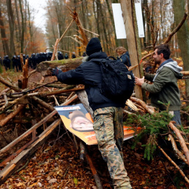 Los manifestantes levantan una barricada de madera después de que los oficiales de policía la desmantelaron durante una protesta contra la extensión de la autopista A49, en un bosque cerca de Stadtallendorf, Alemania.