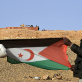 Fotografía de archivo de dos hombres sujetando la bandera del Frente Polisario en el Sáhara.