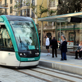 Usuaris esperen el tramvia a l'estació de Verdaguer malgrat l'ajornament de la posada en marxa del servei.