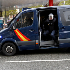 Un manifestante se coloca delante de una furgoneta de la Policía Nacional cerca de un colegio electoral en Barcelona durante el referéndum del 1-O. REUTERS/Yves Herman