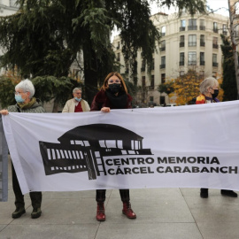 Varias personas sostienen una pancarta que reclama la construcción de un centro para la memoria histórica en la antigua cárcel de Carabanchel, en una manifestación por los derechos de las víctimas del franquismo frente al Congreso de los Diputados, a