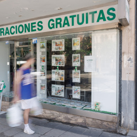 Un mujer pasa por delante de una agencia inmobiliaria en Madrid. E.P./Eduardo Parra