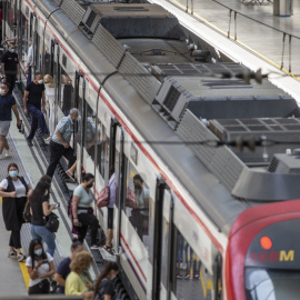 Viajeros suben a un tren de cercanías en la estación de tren de Santa Justa.