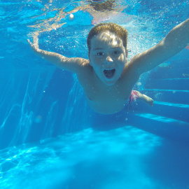 Niño en piscina. Foto de archivo.