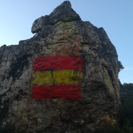 La bandera de España pintada sobre unas pinturas rupestres de hace unos 6.000 años.