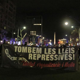 Capçalera de la manifestació 'Tombem les lleis repressives' caminant pel passeig de Gràcia de Barcelona.