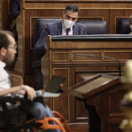 10/11/2021.- El presidente del Gobierno, Pedro Sánchez (c), y la vicepresidenta segunda del Gobierno y ministra de Trabajo, Yolanda Díaz, observan la intervención del portavoz de Unidas Podemos, Pablo Echenique, en una sesión plenaria en el Congreso d