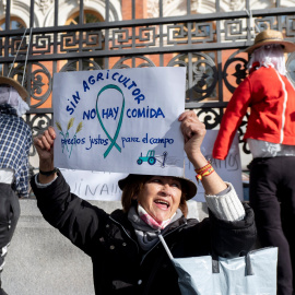 Una mujer con un cartel en el que se lee: 'Sin agricultor no hay comida' durante una concentración de agricultores y exportadores de naranjas, frente al Ministerio de Agricultura, a 24 de noviembre de 2021, en Madrid, (España).