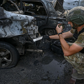 Un experto analiza un coche destruido por las tropas rusas en Vilniansk, a 29 de junio de 2024.