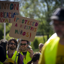 Imagen de archivo de dos manifestantes con pancartas durante la protesta para exigir al Ayuntamiento de Madrid la reubicación del cantón de limpieza que se pretende construir en Montecarmelo