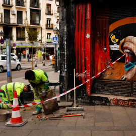 Dos operarios trabajando cerca de un bar cerrado en el centro de Madrid. REUTERS/Susana Vera