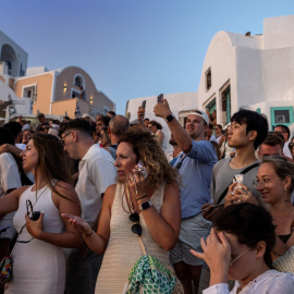 Turistas graban el atardecer en la isla masificada de Santorini, Grecia, a 25 de julio de 2024.